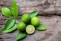 Flat lay cut whole limes wooden table .copy space