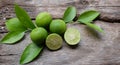 Flat lay cut whole limes wooden table .copy space