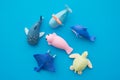 Flat lay of cute aquatic whale, turtle, ray, dolphin, seal toy eraser set on blue background minimal style. Kid learning Royalty Free Stock Photo