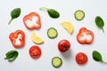 Flat lay design with sliced cucumber, tomato, lemon, bell pepper and spinach leaves Royalty Free Stock Photo