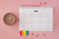 flat lay desk calendar pink background. High quality photo