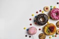 Flat lay of dessert with candy, chocolate and strawberry donuts and fruitcake Royalty Free Stock Photo