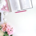 Flat lay with different accessories; flower bouquet, pink roses, open book, Bible Royalty Free Stock Photo