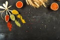 Flat lay of different kinds of colorful spices in spoons on black stone surface Royalty Free Stock Photo