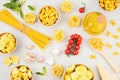 Flat lay with different types of traditional italian pasta. Penne, tagliatelle, fusilli, farfalle, spaghetti and cooking ingredien Royalty Free Stock Photo