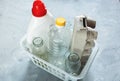 Flat lay of different wastes ready for recycling in white basket. Plastic, glass, paper. Social responsibility, ecology care Royalty Free Stock Photo