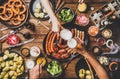 Flat-lay of dinner table with beer, Bavarian sausages and snacks Royalty Free Stock Photo