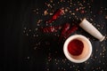 Crushed chili powder in a mortar with pestle and red chilies around it isolated on black background with blank space. Royalty Free Stock Photo