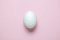 Flat lay of Easter egg on plain pink background