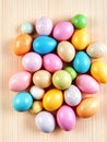 A Flat Lay of Easter Eggs in Multiple Colors and Finishes, Spread Across a Light Wooden Plank Surface. Royalty Free Stock Photo