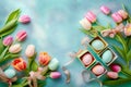 flat lay of Easter eggs with tulip flowers and gift boxes on blue gray background. space for text Royalty Free Stock Photo