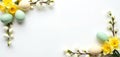 Flat lay Easter frame features daffodils, colored eggs. White background provides copy space. Floral spring composition perfect Royalty Free Stock Photo