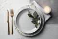 Flat lay of an empty white plate and napkin on a table top made of light grey marble Royalty Free Stock Photo