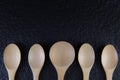 Flat lay An empty wooden spoon, five pieces Placed on a black background empty wooden spoon, five pieces Placed on a black backg