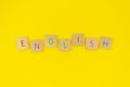 Flat lay English word made from wooden blocks with letters, learn how to speak English concept