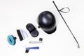 Flat lay of equestrian gear: helmet, brushes, whip, bandages, stirrups, pads, dressage, bridle. Royalty Free Stock Photo