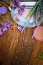 Flat lay eye shadow palette and lavender flowers against wood background