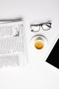 flat lay with eyeglasses, coffee, digital tablet and newspapers, on white Royalty Free Stock Photo