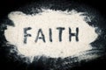 Flat lay of Faith word written on sand Royalty Free Stock Photo