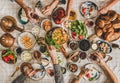 Flat-lay of family having Turkish breakfast over chekered linen tablecloth Royalty Free Stock Photo