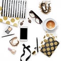 Flat lay fashion feminine home office workspace with phone, cup of coffee, stylish black gold notebooks, cosmetics and jewelry on Royalty Free Stock Photo