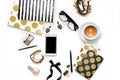 Flat lay fashion feminine home office workspace with phone, cup of coffee, stylish black gold notebooks, cosmetics and jewelry on Royalty Free Stock Photo