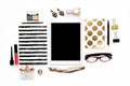 Flat lay fashion feminine home office workspace with phone, cup of coffee, stylish black gold notebooks, cosmetics and jewelry on Royalty Free Stock Photo