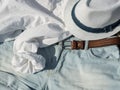 Flat lay fashion women summer beachwear accessories: shorts, shirt, hat, belt. Travel vacation background. Top view