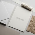 Paper labeled BRAND NAME, a textured tan paper, and a rolled-up white Royalty Free Stock Photo