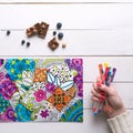 Flat lay, female coloring adult coloring book