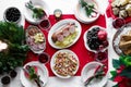 Flat-lay of festive table setting for holiday dinner with dishes. Traditional Italian Christmas dinner - potatoes with Cotechino, Royalty Free Stock Photo