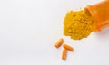 Flat lay of finely dry Turmeric powder and capsules