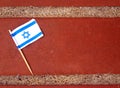 Flat lay of the flag of Israel on a brick surface