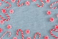 Flat lay frame of Christmas candy canes and peppermint swirl candies