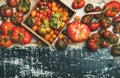 Flat -lay of fresh colorful ripe tomatoes over rustic background Royalty Free Stock Photo