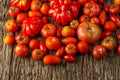 Flat-lay of fresh colorful ripe Fall or Summer heirloom tomatoes variety over rustic background, top view, copy space. Royalty Free Stock Photo