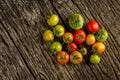 Flat-lay of fresh colorful ripe Fall or Summer heirloom tomatoes variety over rustic background, top view, copy space. Royalty Free Stock Photo