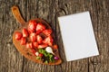 Flat-lay of fresh colorful ripe Fall or Summer heirloom tomatoes variety over rustic tray background with blank paper Royalty Free Stock Photo