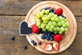 flat lay, fresh fruits with a heart slate on wooden table, copyspace Royalty Free Stock Photo