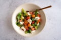 Flat-lay of a fresh Italian caprese salad in a white bowl, vegetarian food