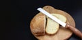 Flat-lay of freshly baked bread loaf, bread slices and sharp knife on rustic wooden board Royalty Free Stock Photo