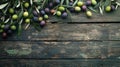 A flat lay of freshly picked olives on a rustic wooden surface Royalty Free Stock Photo