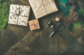 Flat-lay of gift boxes, rope, fur branches, scissors, wooden background Royalty Free Stock Photo