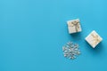 Flat lay gift boxes and snowflake on a blue background. Festive Christmas background, minimal
