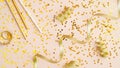 Flat lay gold confetti star and party streamers on beige table. Celebration background top view. Christmas, birthday or wedding Royalty Free Stock Photo