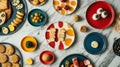 A flat lay of gourmet snacks and vibrant serving platters on a marble surface. digital Royalty Free Stock Photo