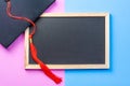 Flat lay of graduate cap and blackboard Royalty Free Stock Photo