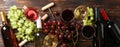 Flat lay. Grapes, corkscrew, bottles and glasses with wine on wooden Royalty Free Stock Photo