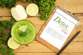 Flat lay green diet detox drink with guava, lime, celery on wood