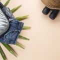 Flat lay grey suitcase with binoculars, hat, jeans on pastel background. travel concept - Image Royalty Free Stock Photo